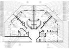 Floor plan of a building with multiple wings and an open central area. Lines and labels indicate layout details.