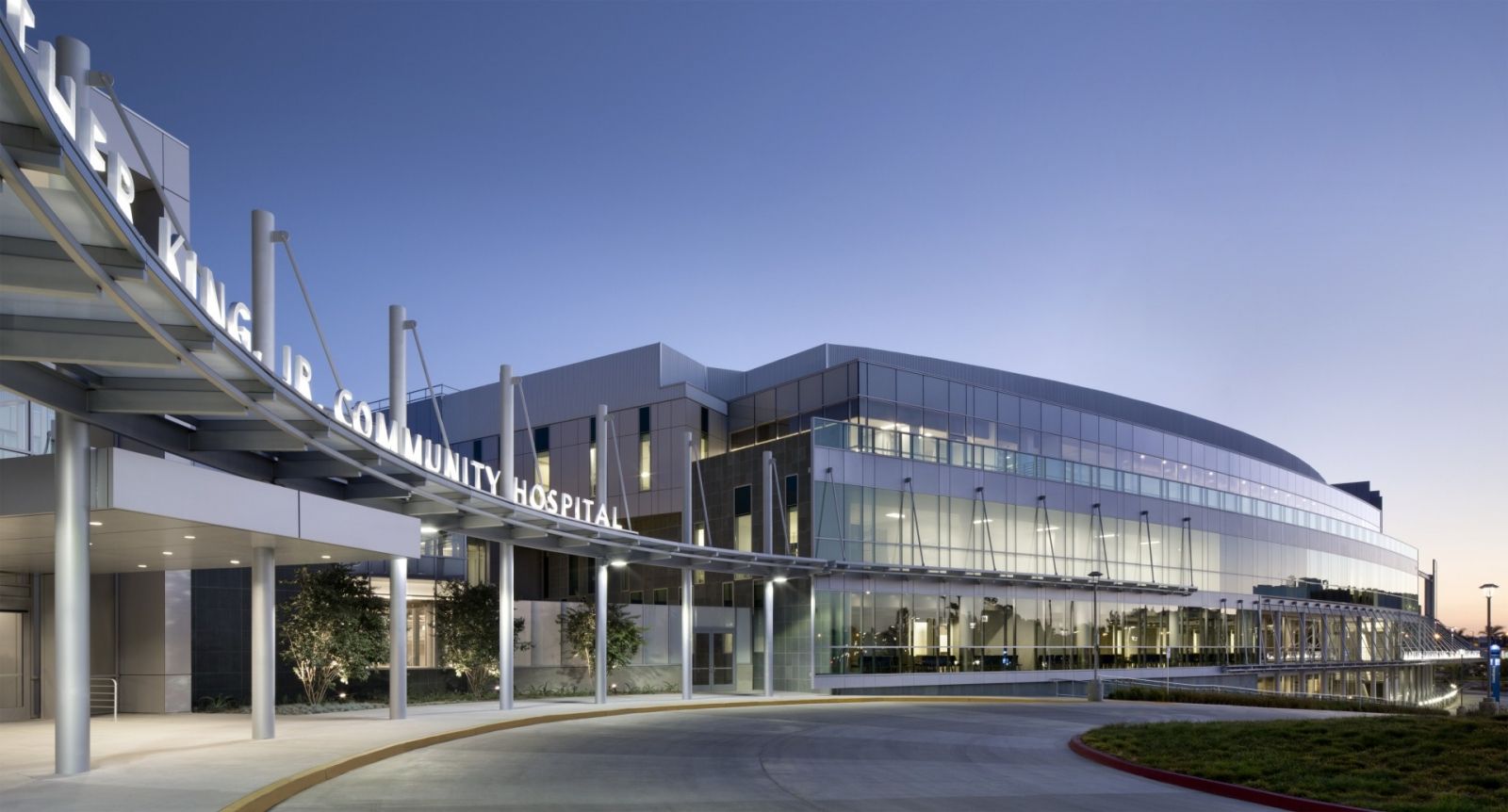 A large building with a lot of windows and a canopy over the entrance.