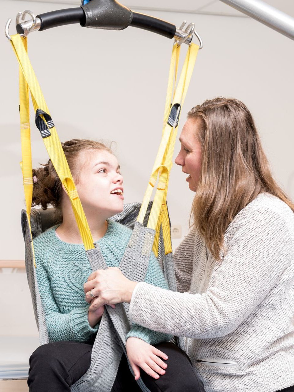 A nurse helping a PWD patient in therapy