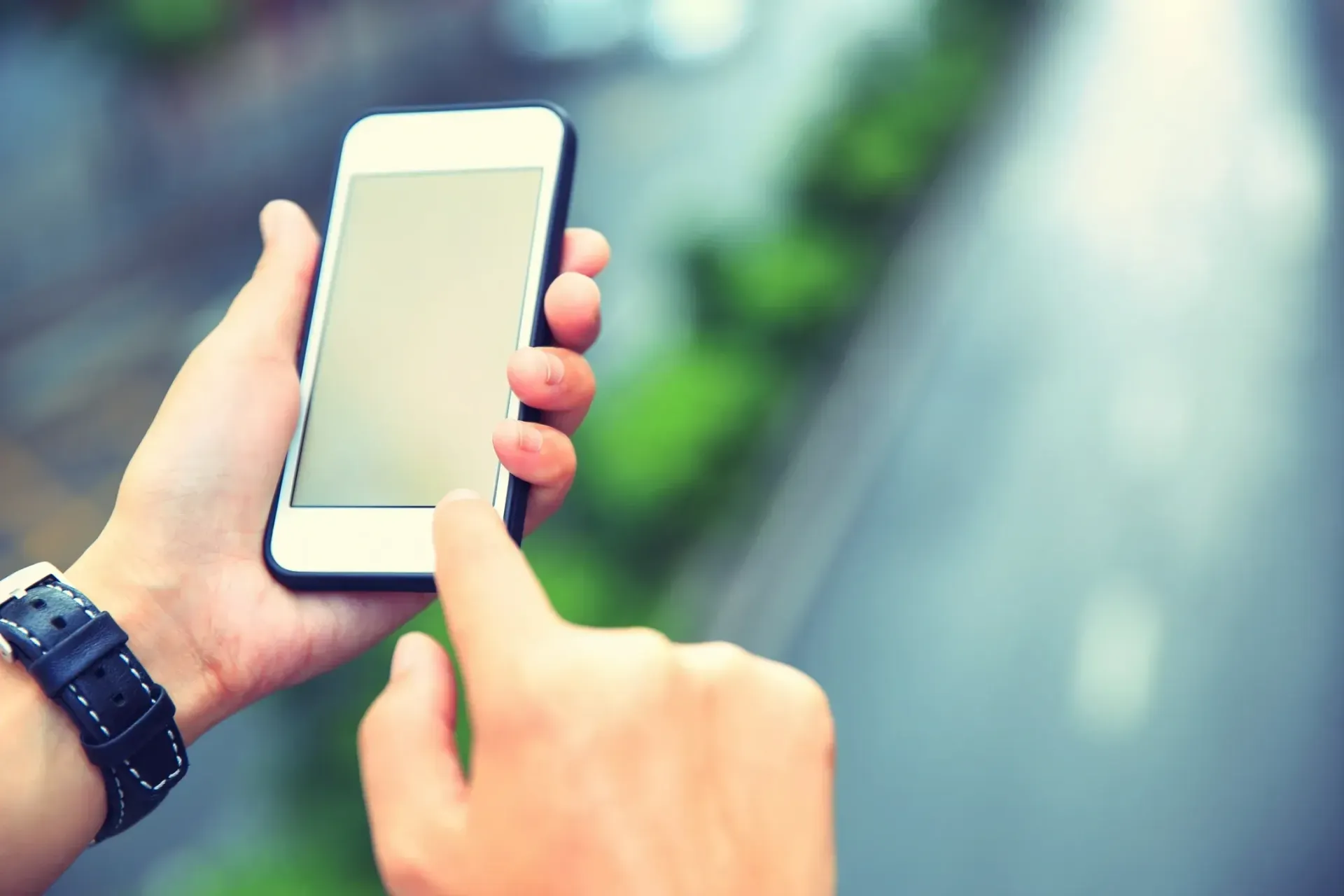 A person is holding a cell phone in their hand.