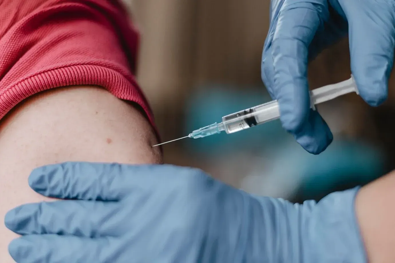 A person is getting a vaccine in their arm.