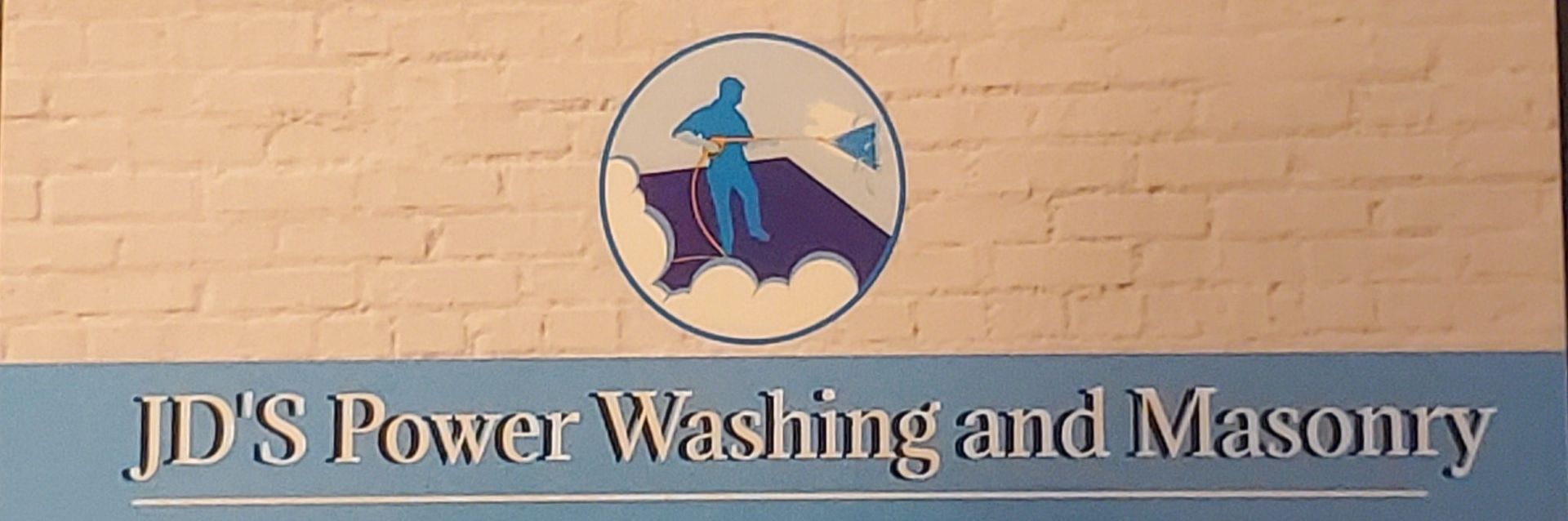 Logo for JD's Power Washing and Masonry featuring a circular icon of a person using a power washer against a brick wall.