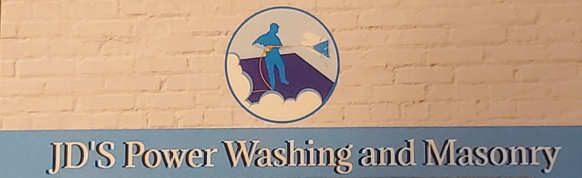 Logo for JD's Power Washing and Masonry featuring a blue graphic of a person pressure washing on a brick wall background.