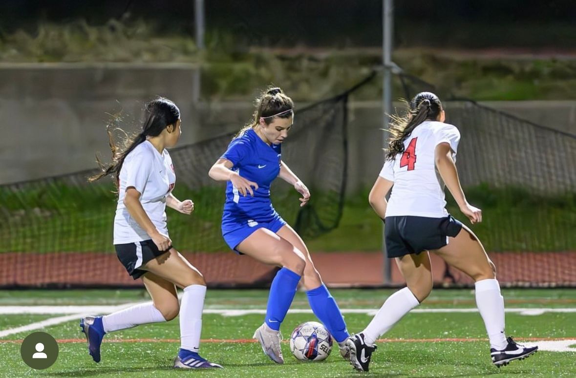Player cutting back with soccer ball.