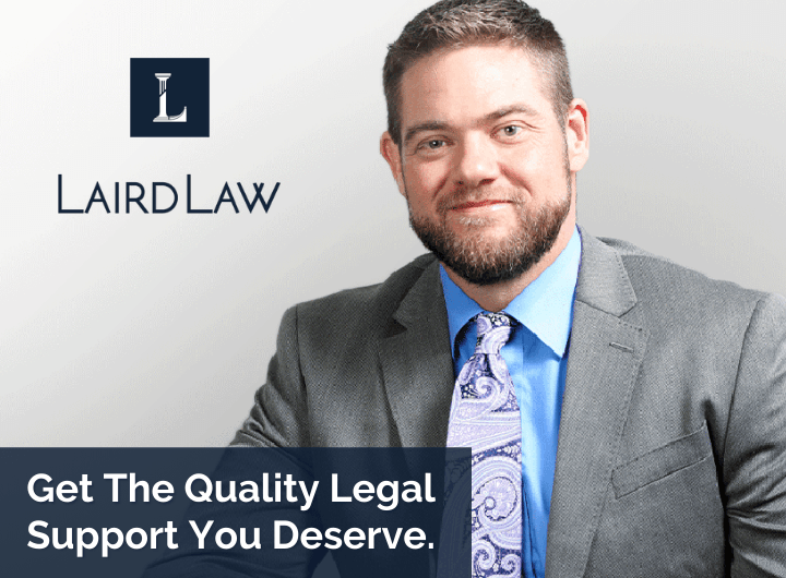 A man in a suit and tie is sitting in front of a laird law logo