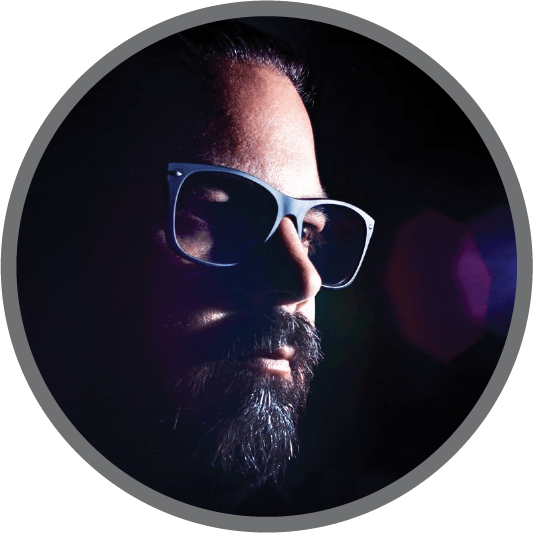 A man with a beard wearing sunglasses in a circle