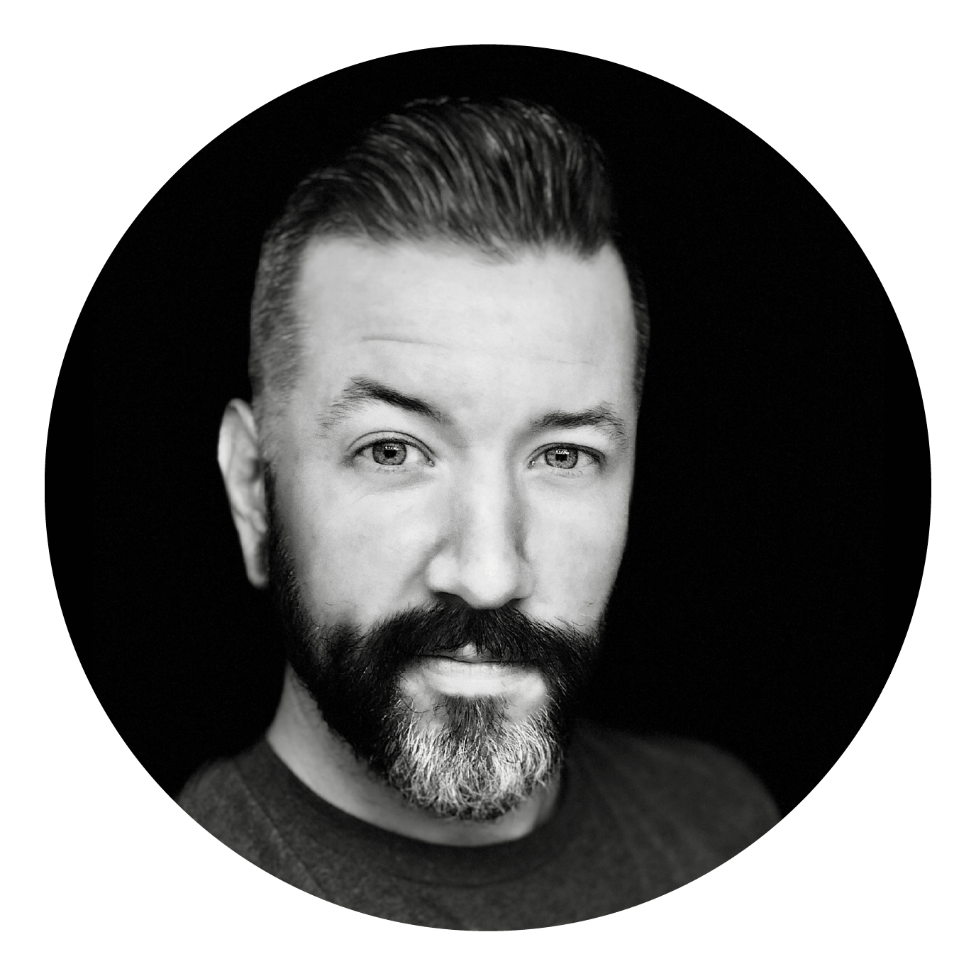 A black and white photo of a man with a beard