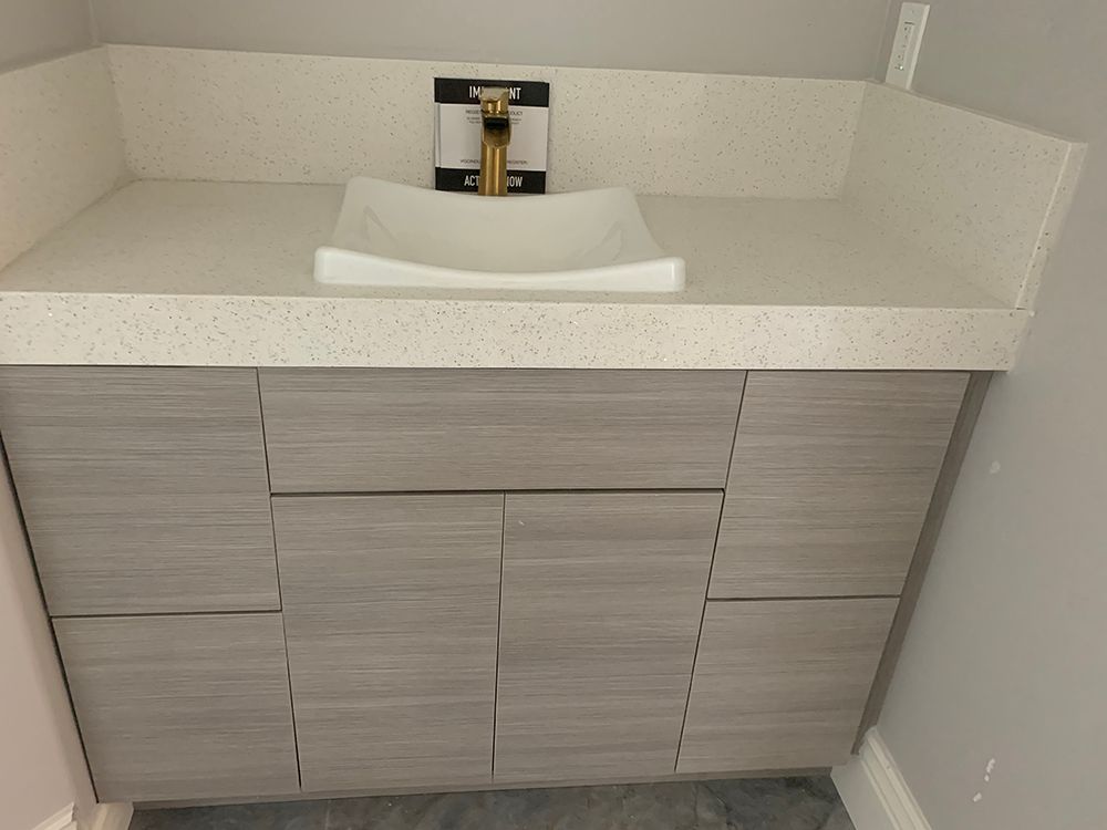 Contemporary gray cabinets below bathroom sink