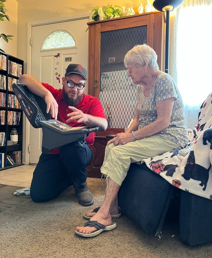 A group of men are sitting at a long table in a room.