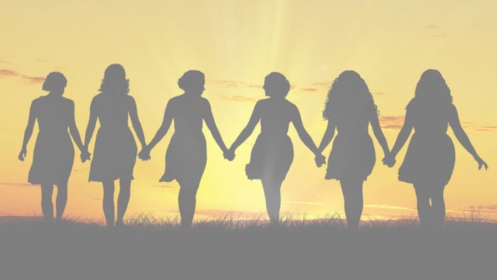 Silhouette of women joined in hands