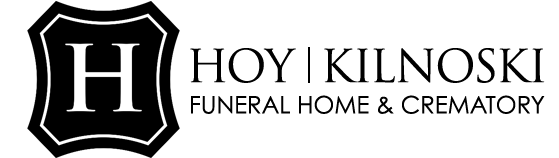 Logo for Hoy Kilnoski Funeral Home & Crematory, with a black shield containing a white 