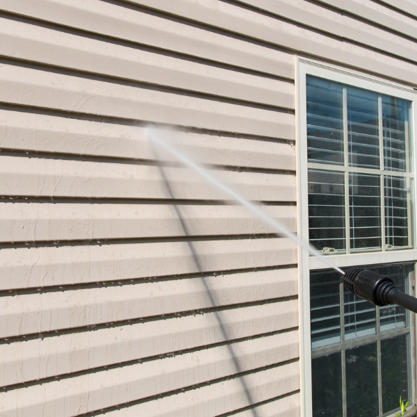Power washing a house to get rid of grime