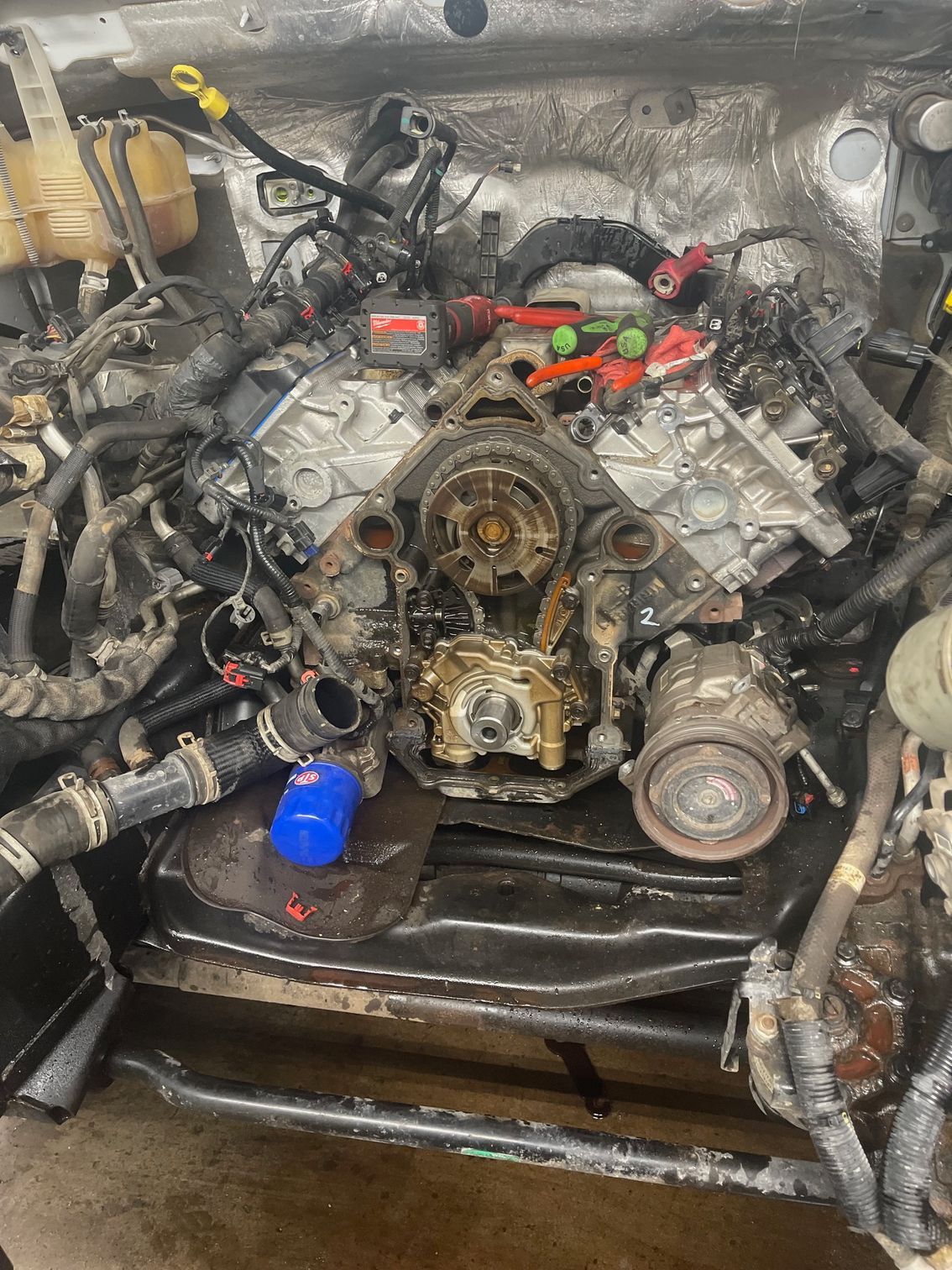 A car engine is being worked on in a garage.