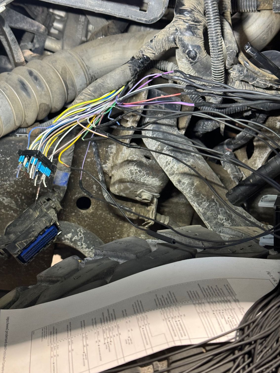 A bunch of wires are connected to a car engine.