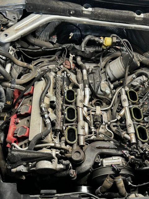 A car engine with a lot of wires coming out of it