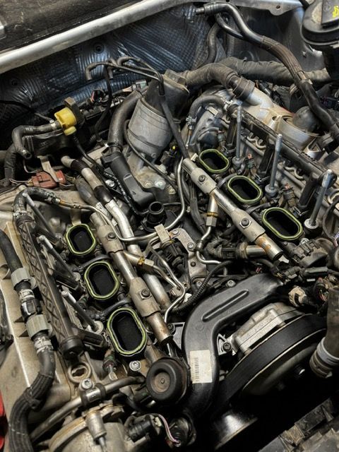 A close up of a car engine with the intake manifold removed