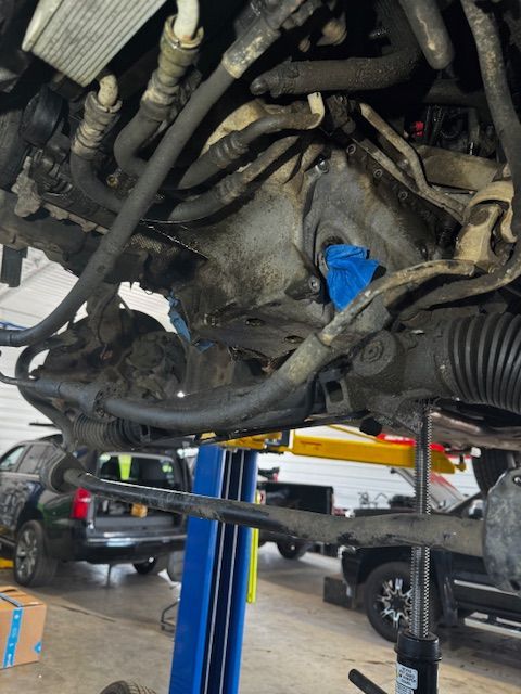 A car is sitting on a lift in a garage