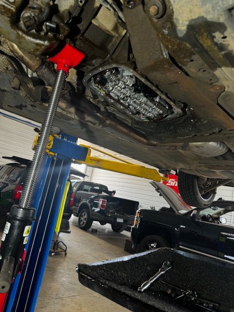 A car is sitting on a lift in a garage