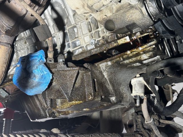 A close up of a car engine with a blue cloth on it
