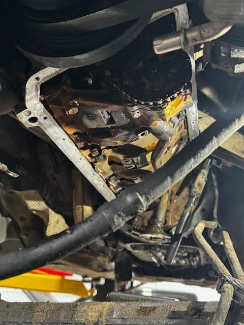 A close up of the underside of a car with the engine removed