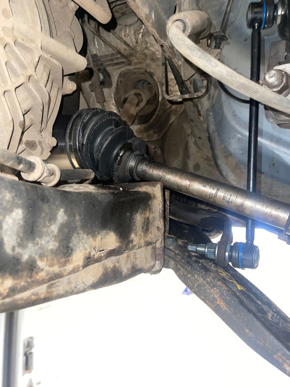 A close up of the underside of a car 's suspension system.