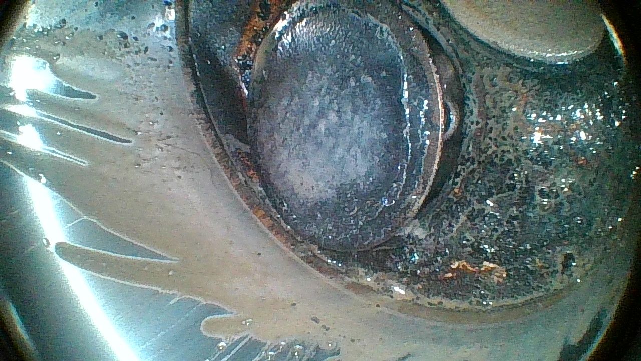 A close up of a metal object under a magnifying glass.