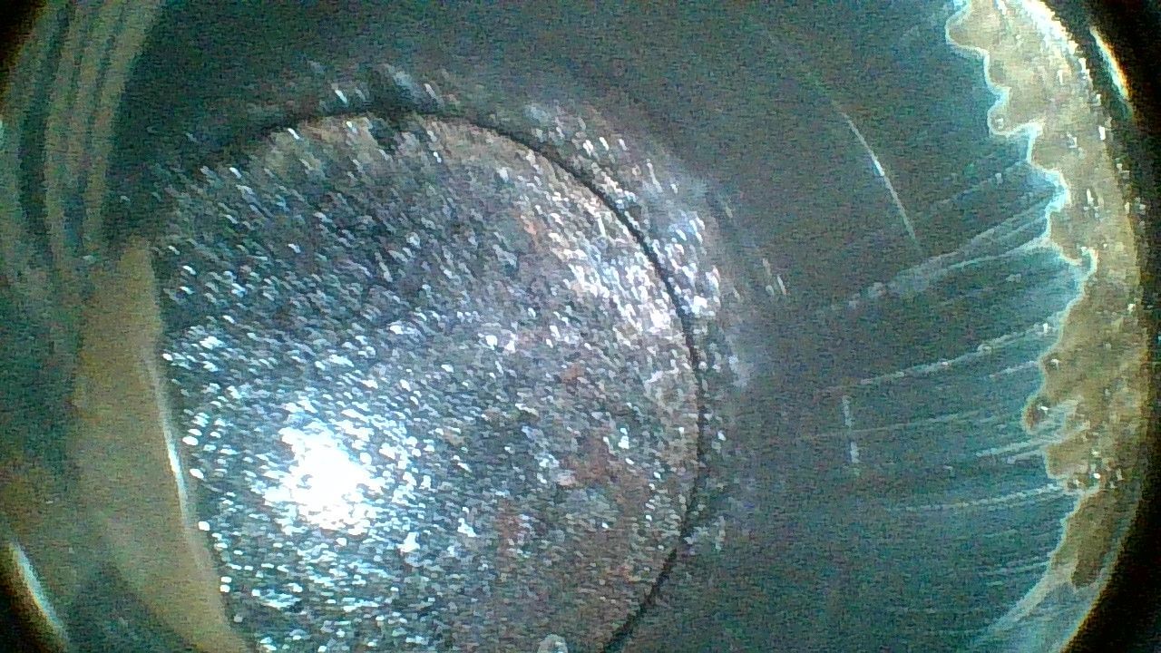 A close up of a metal pipe with a hole in it.