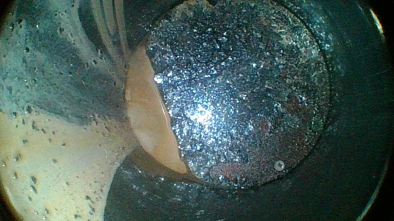 A close up of a metal object in a dark room.