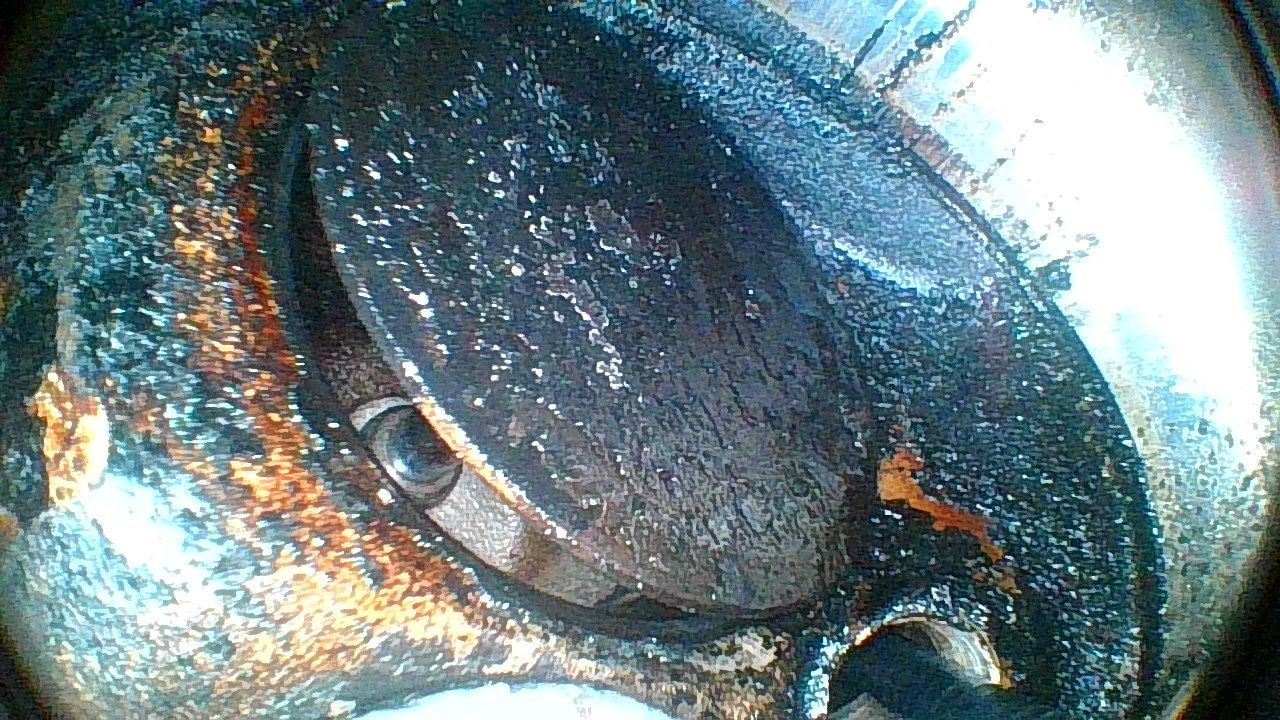 A close up of a piece of metal with a hole in it.