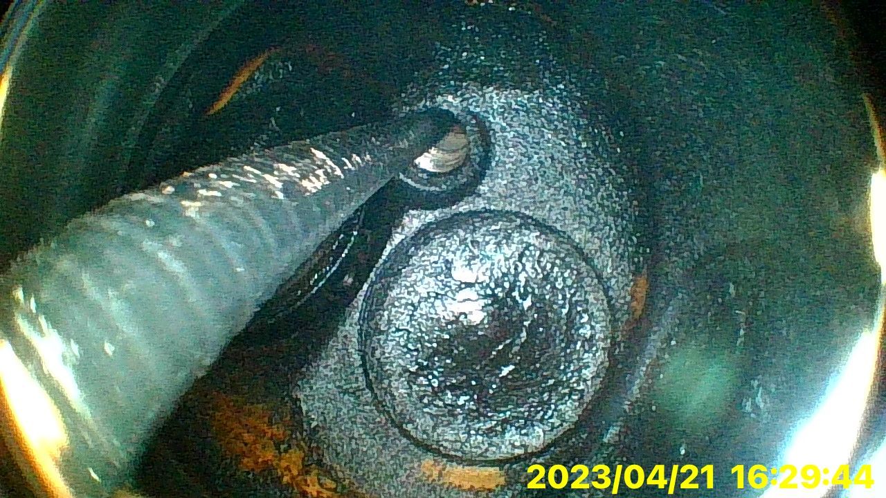 A close up of a hole in a metal object.