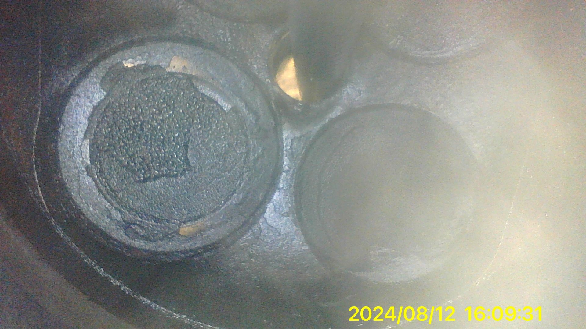 A close up of a black object with a yellow sticker on it.