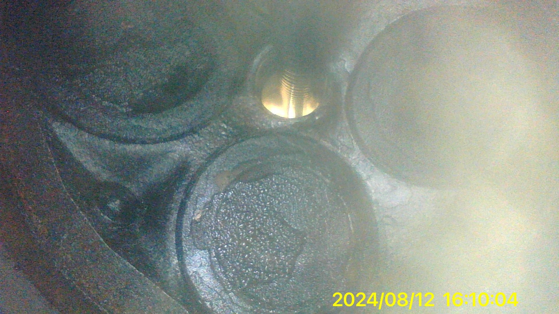 A close up of a metal object with a smoke coming out of it.