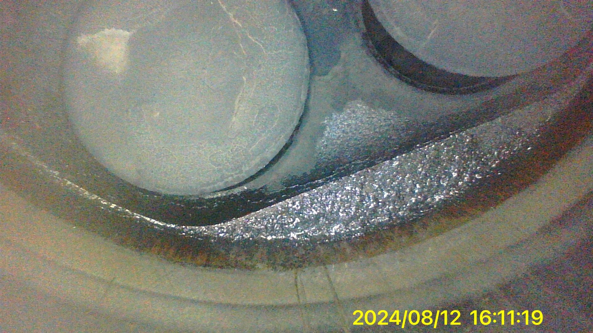 A close up of a metal object with a timestamp of 2024/08/12.