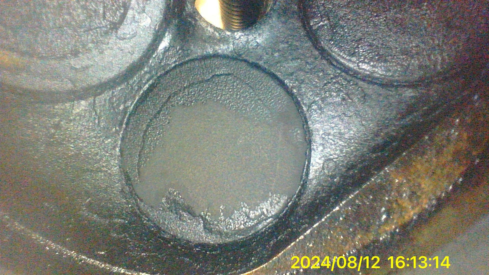 A close up of a metal object with a hole in it.