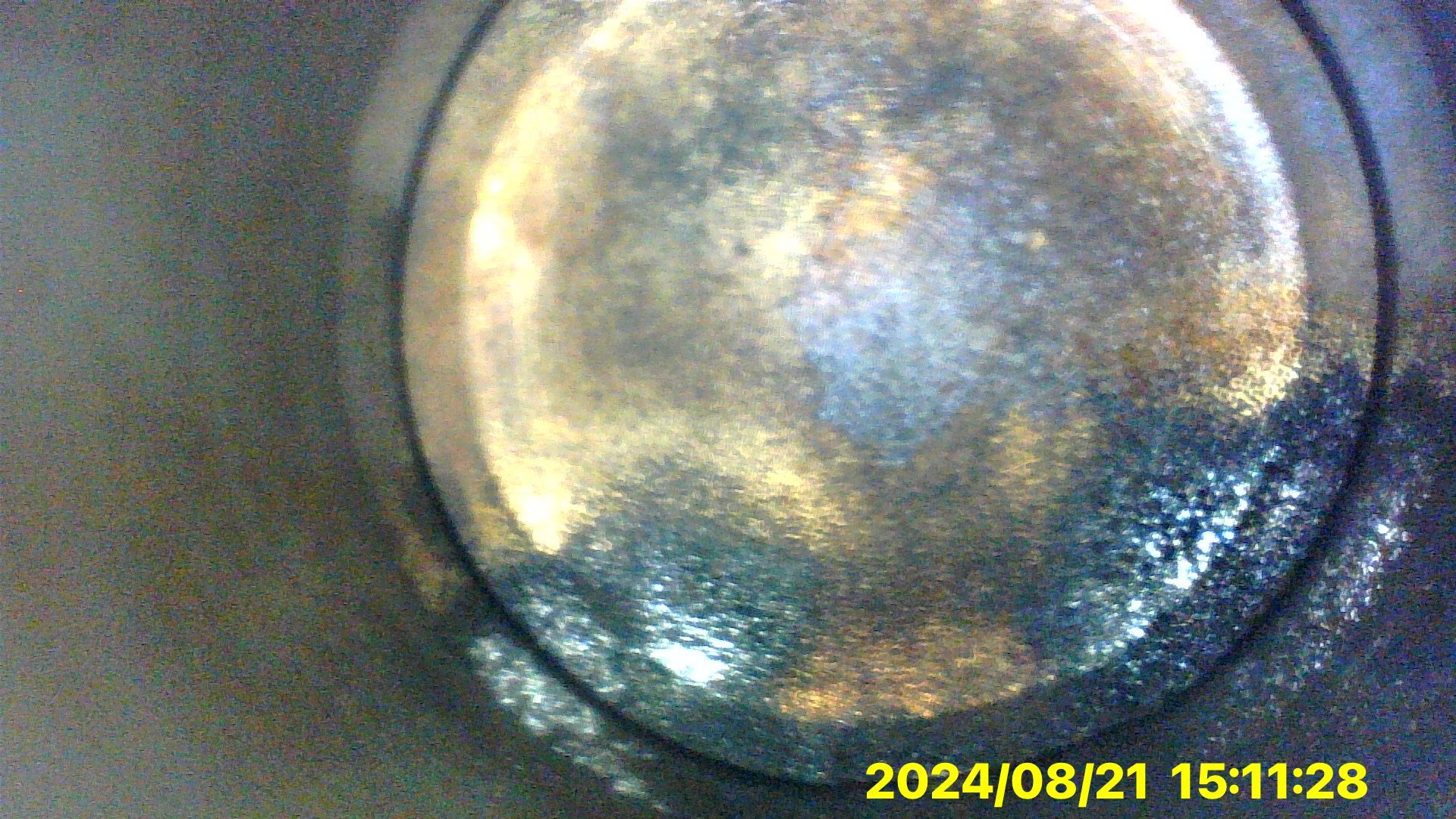 A close up of a metal object with a time stamp on it.