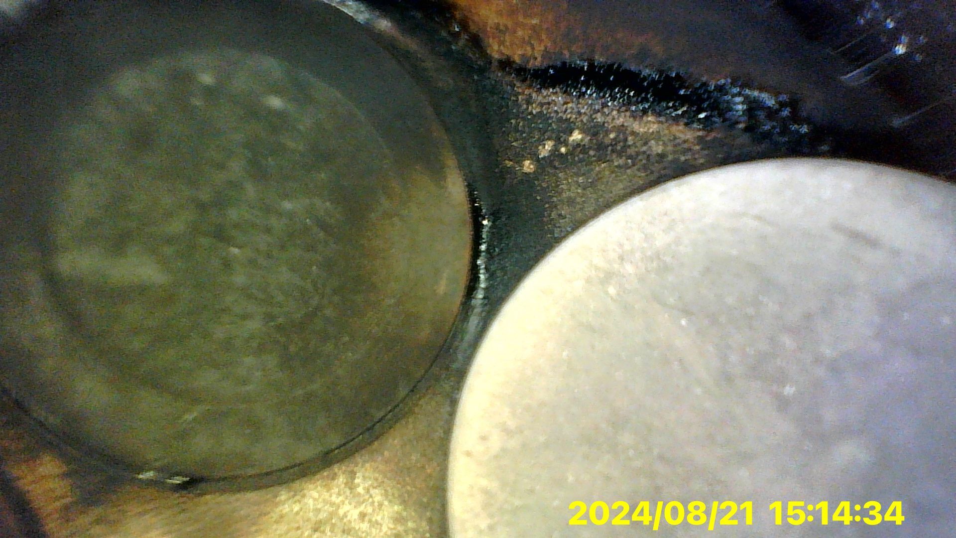 A close up of a piston in a car engine.