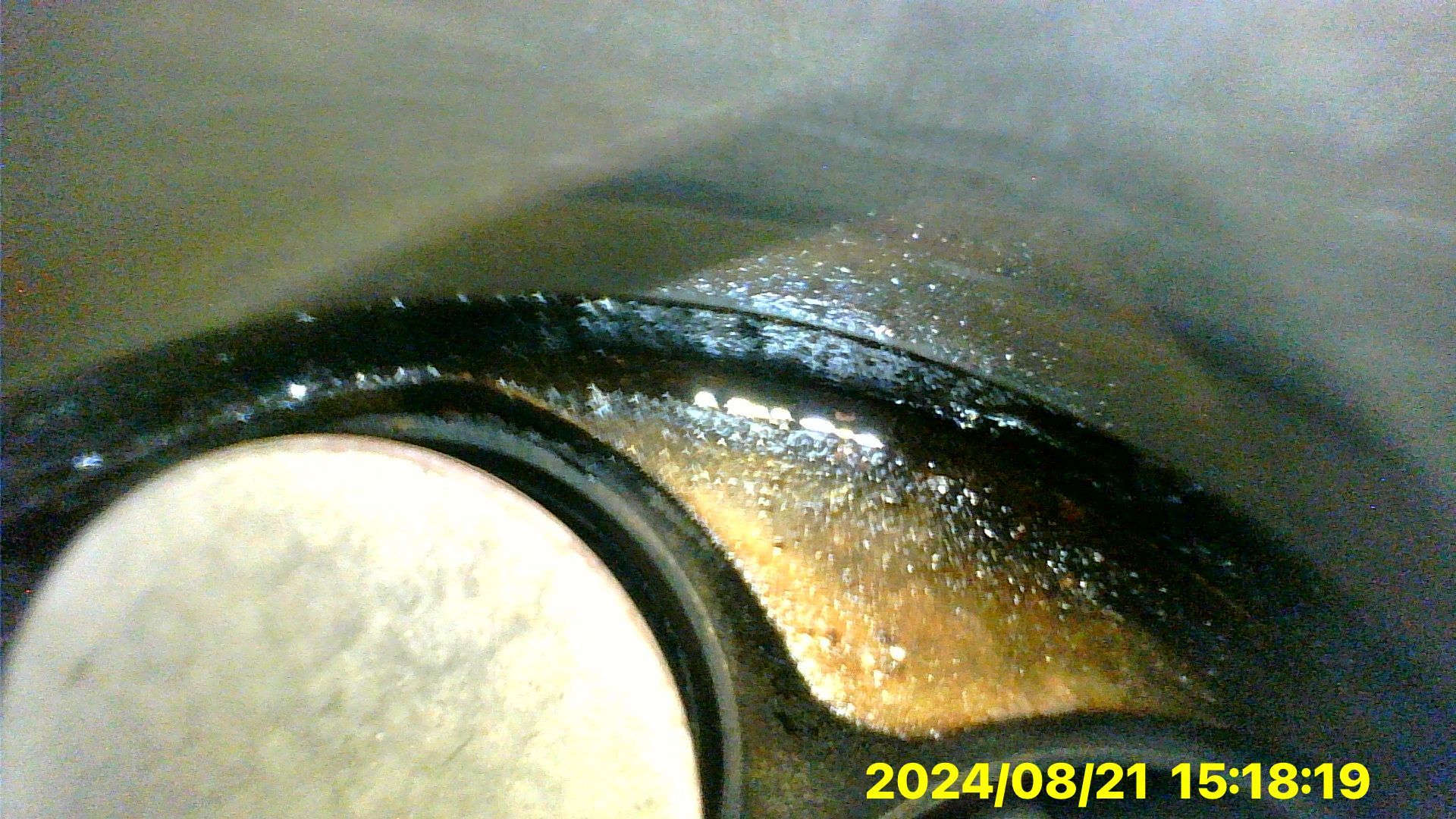 A close up of a metal object with a timestamp of 2024/08/21