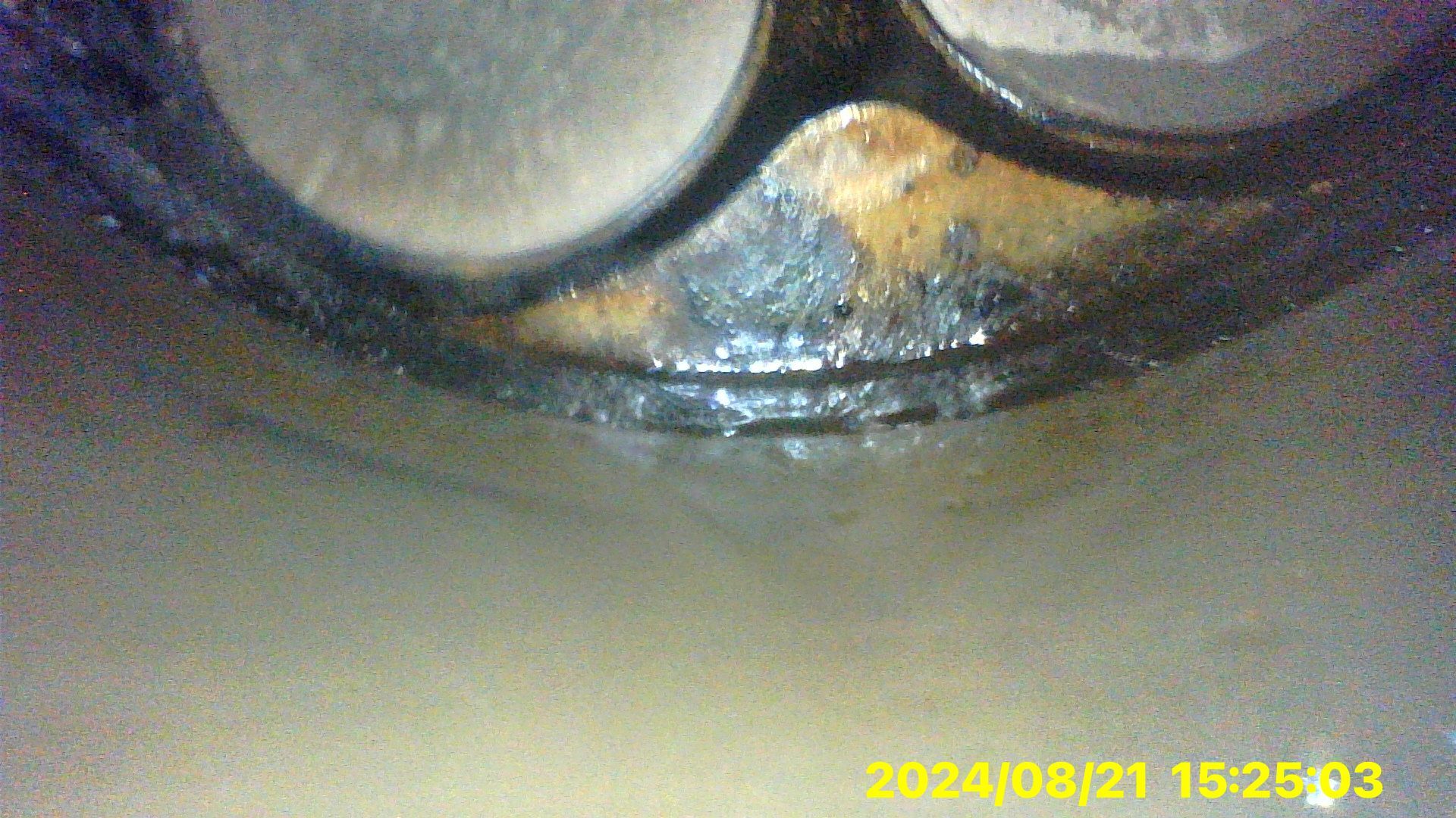 A close up of a metal object with a time stamp on it.