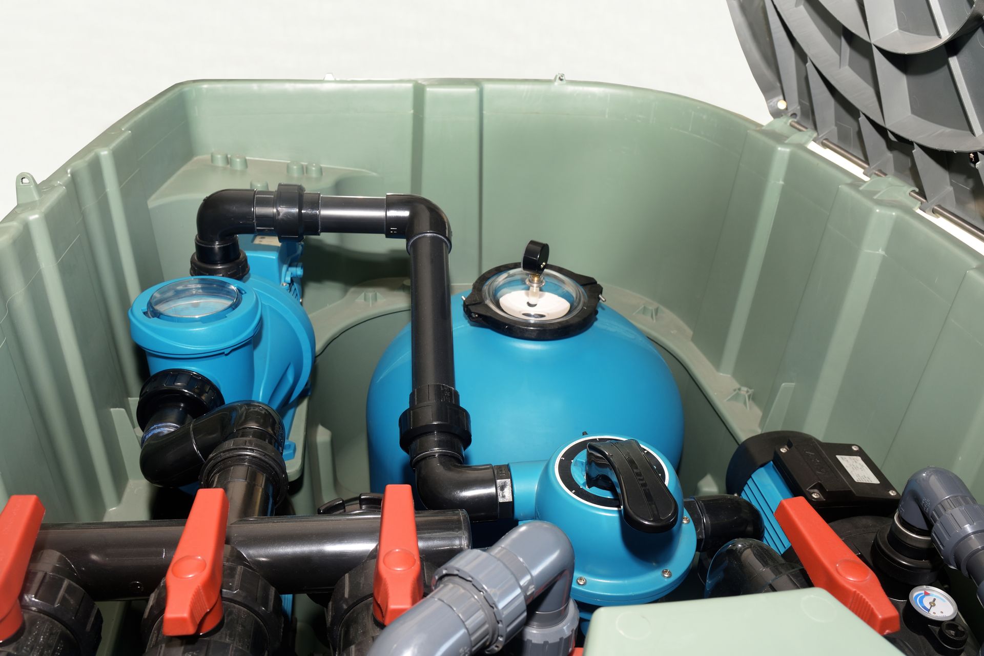 The inside of a swimming pool with a filter and valves