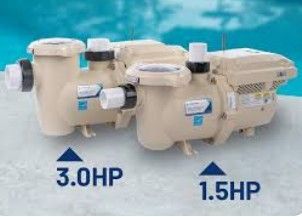 Two beige pool pumps labeled 3.0 HP and 1.5 HP, beside a blue pool. Two beige pool pumps labeled 3.0 HP and 1.5 HP, beside a blue pool.