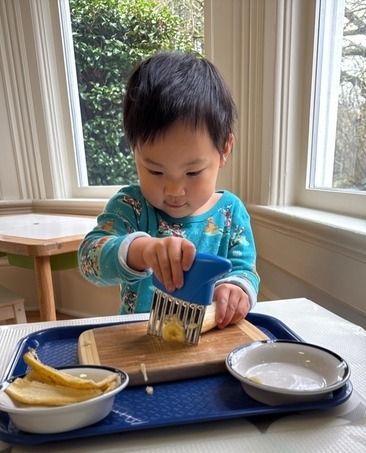 Montessori child picking flowers