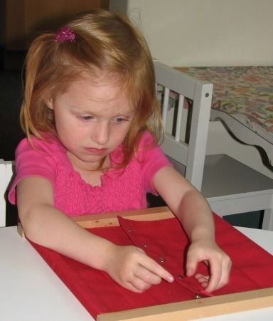 Montessori child working with snapping frame