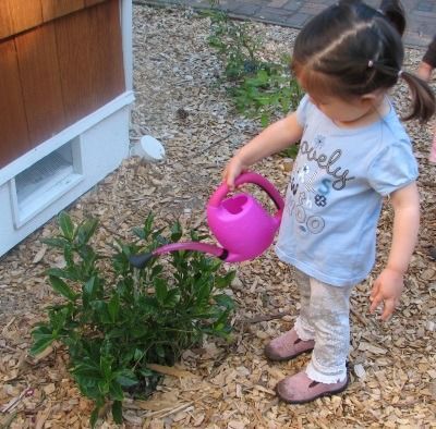 Montessori toddler watering plants