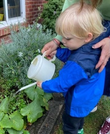 Montessori toddler watering plants