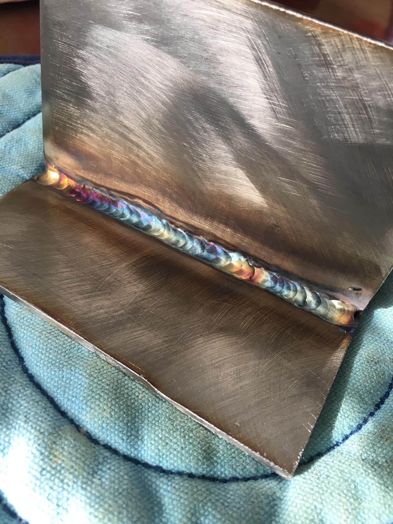 A warehouse filled with lots of metal rolls stacked on top of each other.