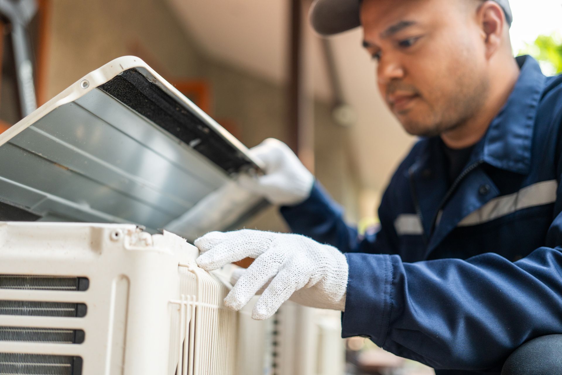 HVAC technician servicing a residential heating and cooling system in Maple Valley, Washington.