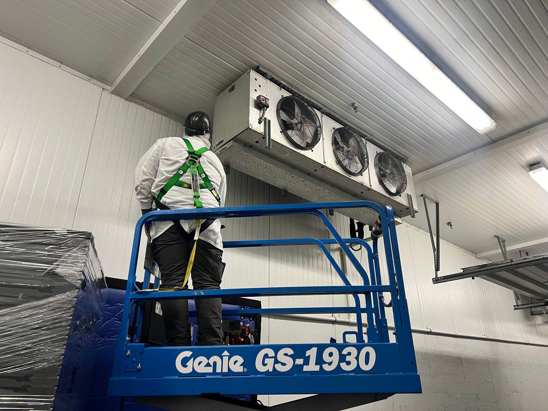 Two air conditioners are sitting on the side of a house installed by Pro Temp.