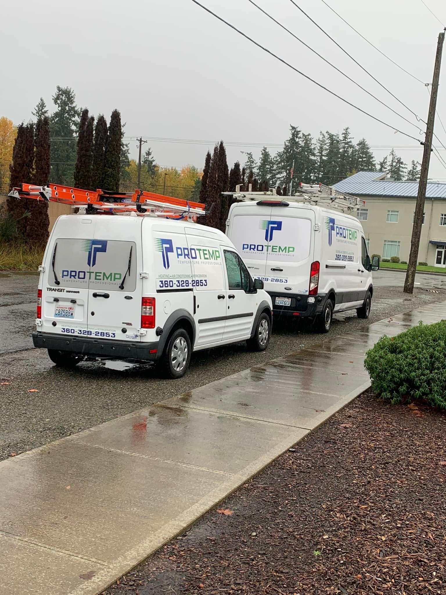 A family is sitting on a couch laughing together.