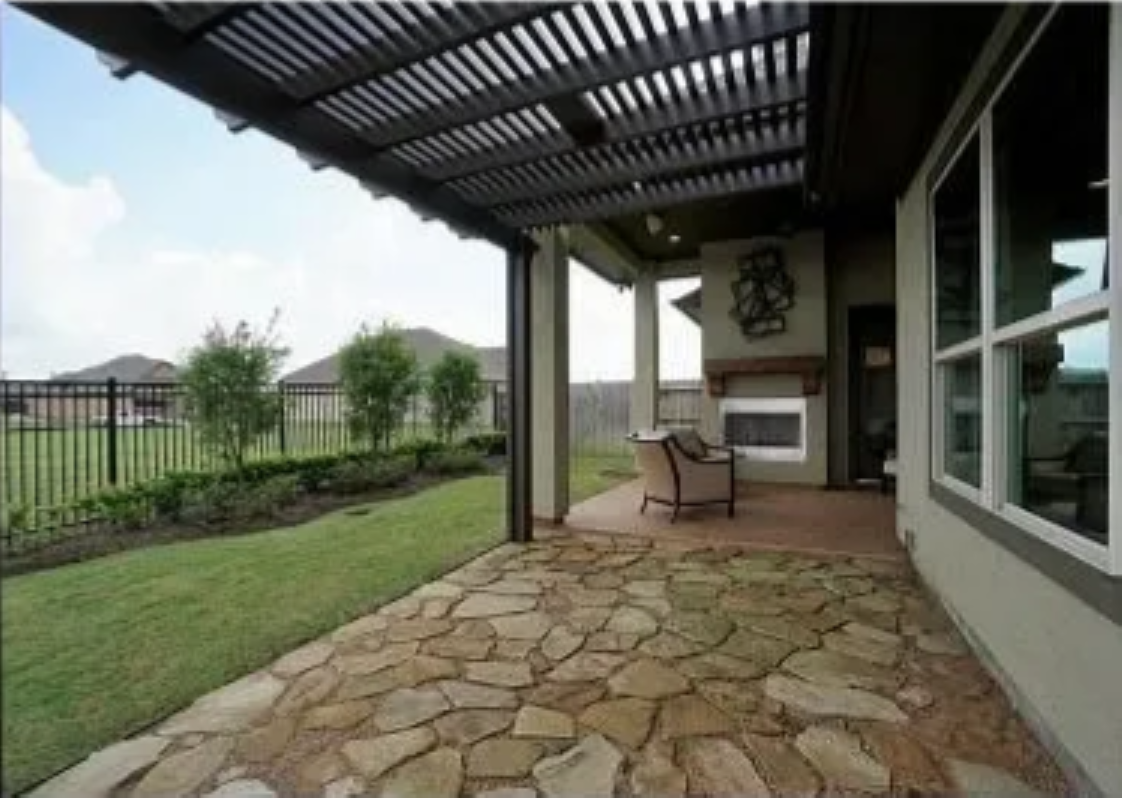 Dark bronze Alumawood pergola attached to home exterior in Stone Oak neighborhood of San Antonio.