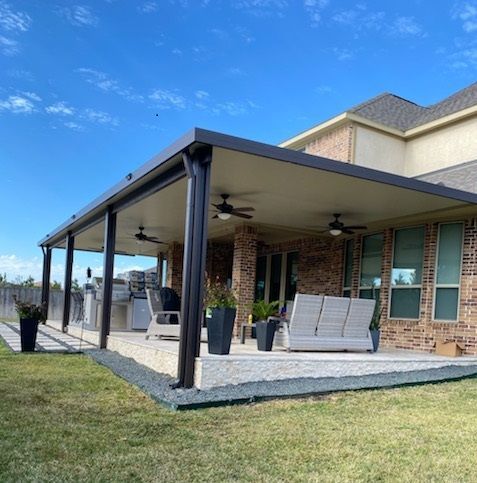 Aluminum Patio Cover in Austin with a concrete slab & outdoor kitchen.